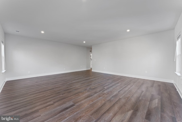 unfurnished room with dark hardwood / wood-style flooring