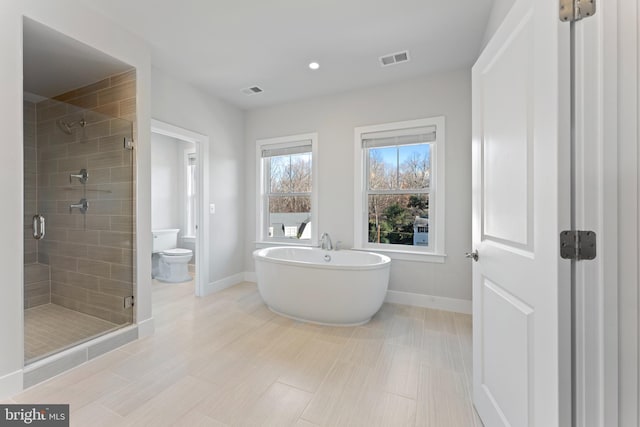 bathroom featuring separate shower and tub and toilet