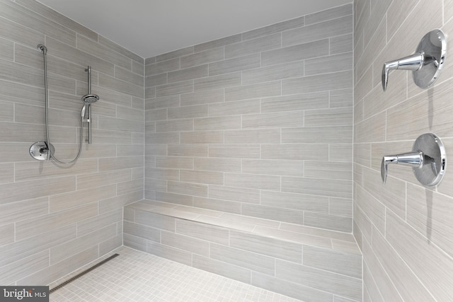 bathroom with a tile shower