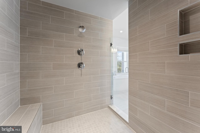 bathroom with a tile shower