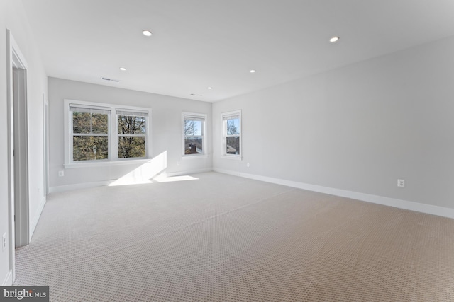 unfurnished room featuring light carpet