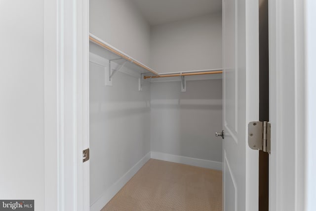 walk in closet with tile patterned floors