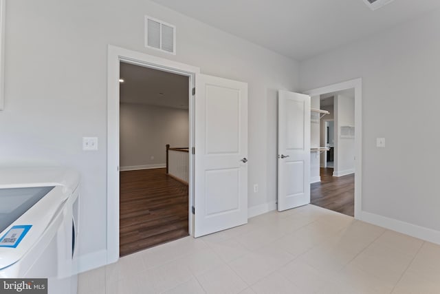 unfurnished bedroom with washer and dryer