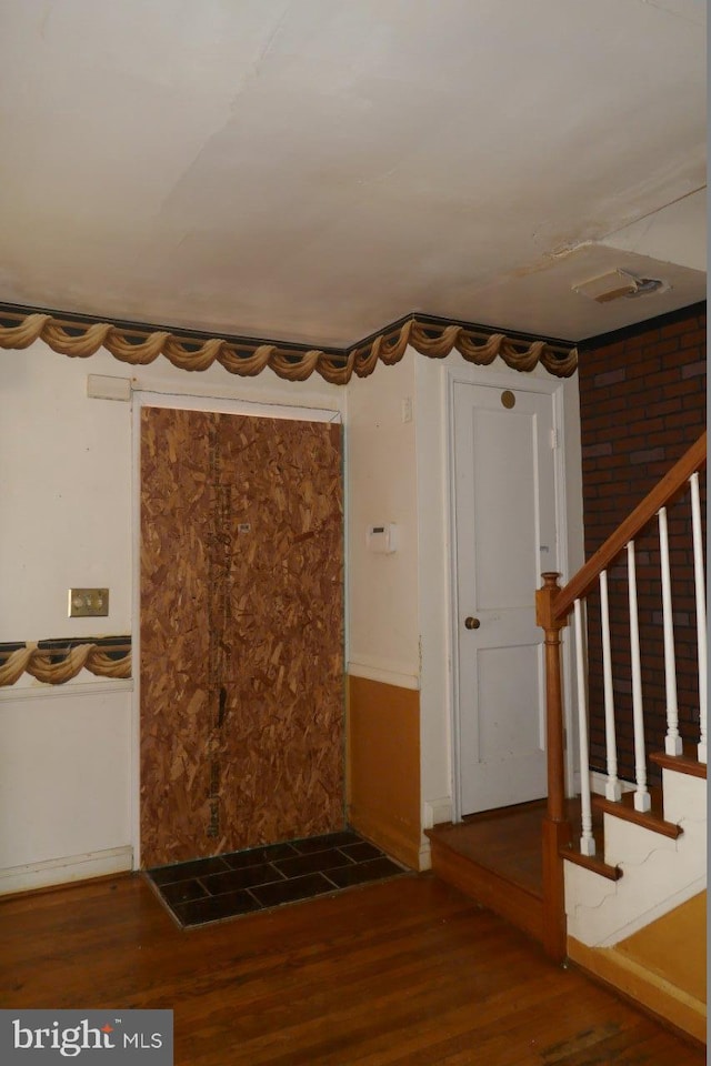 entryway with dark hardwood / wood-style floors