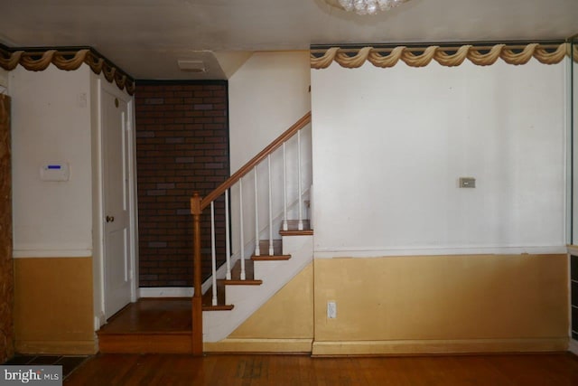 stairs featuring hardwood / wood-style flooring