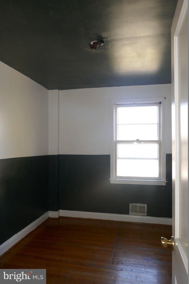 unfurnished room featuring dark hardwood / wood-style floors