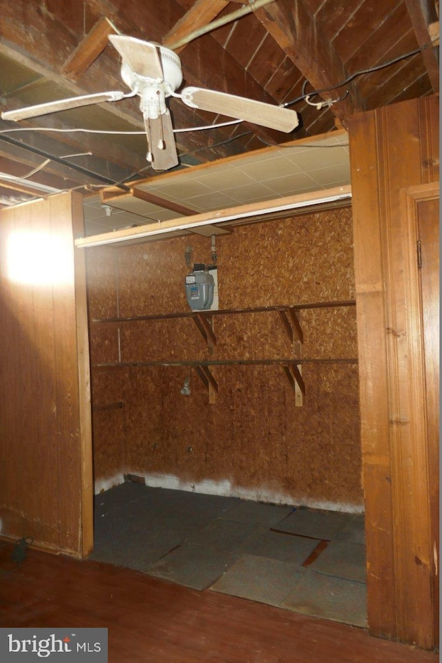 basement with wood-type flooring and wood walls