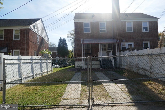 rear view of property with a lawn