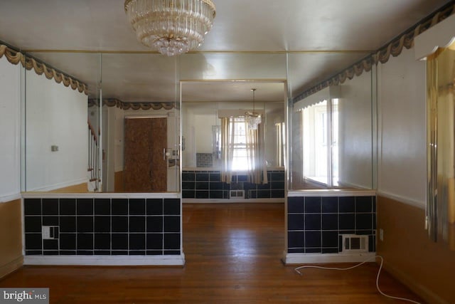 bathroom featuring hardwood / wood-style floors and a notable chandelier