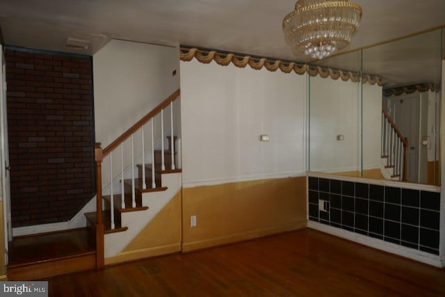 basement with hardwood / wood-style floors and a chandelier