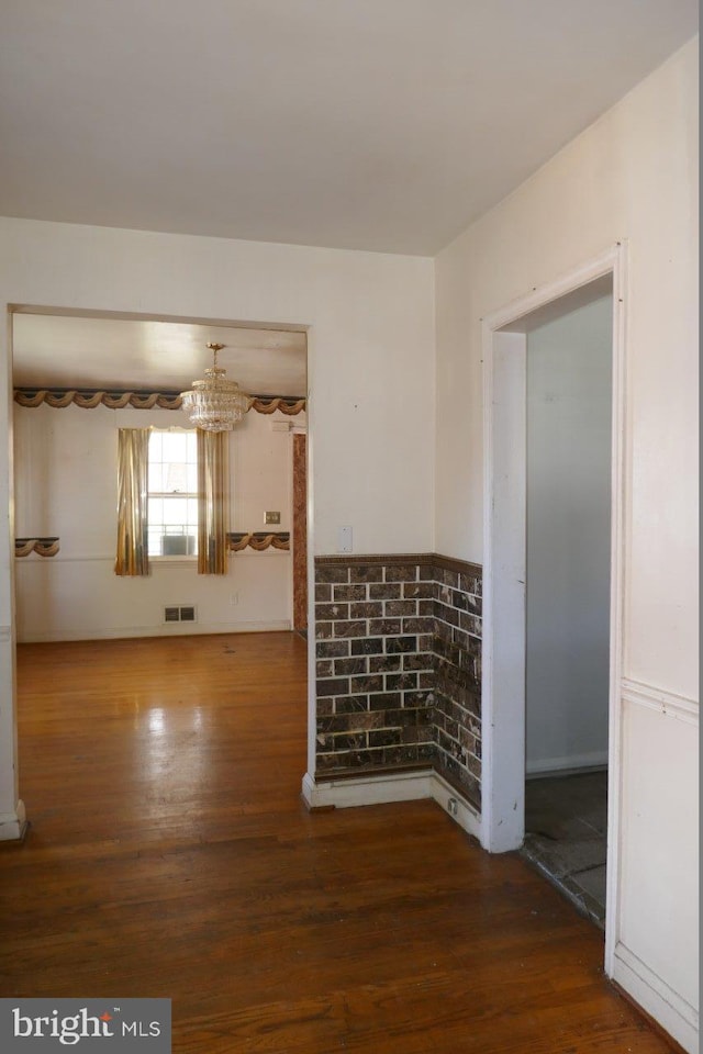 empty room featuring wood-type flooring