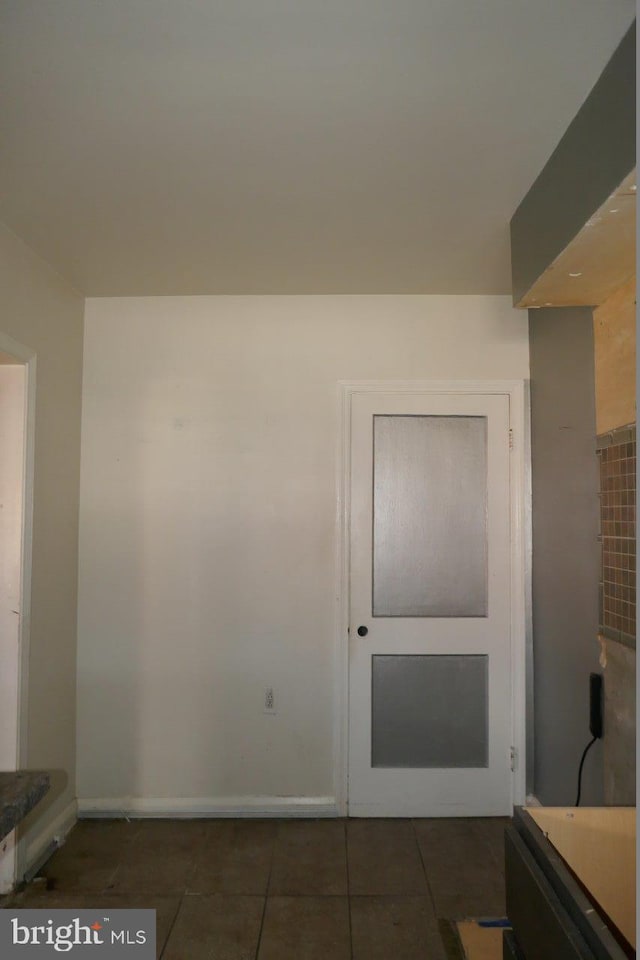 interior space featuring dark tile patterned floors