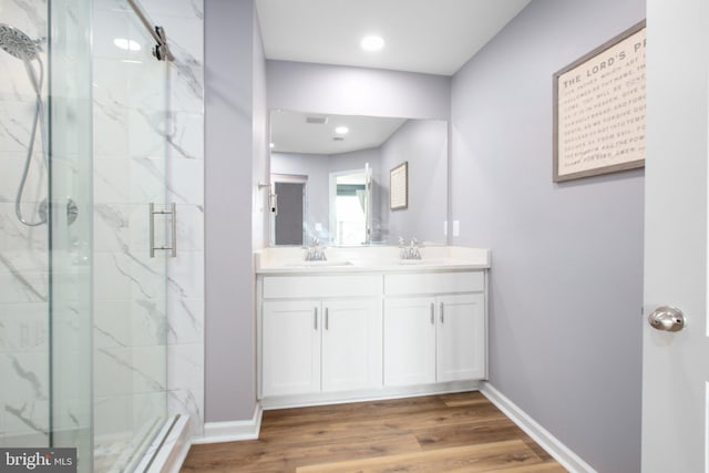 bathroom featuring vanity, wood-type flooring, and an enclosed shower