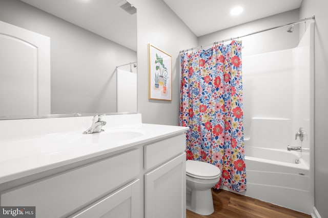 full bathroom featuring vanity, hardwood / wood-style flooring, toilet, and shower / bathtub combination with curtain