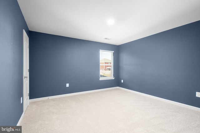 unfurnished room with light colored carpet