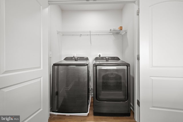 washroom featuring washer and dryer and dark hardwood / wood-style flooring