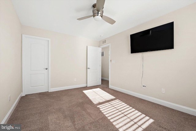 unfurnished bedroom featuring ceiling fan and dark carpet