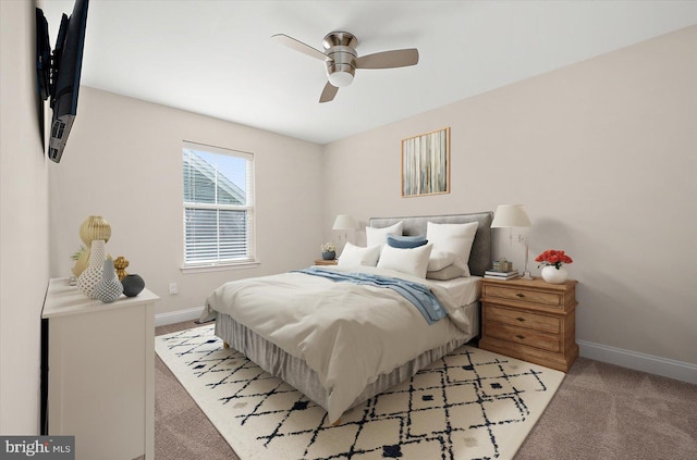 bedroom featuring light carpet and ceiling fan