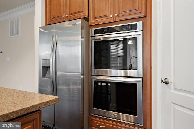 kitchen with ornamental molding and stainless steel appliances