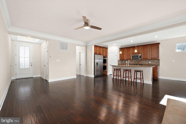 unfurnished living room featuring dark hardwood / wood-style floors, ceiling fan, and crown molding