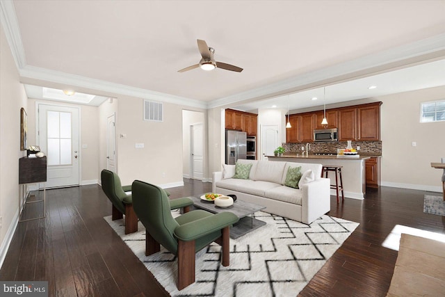 living room with ceiling fan, dark hardwood / wood-style floors, and ornamental molding