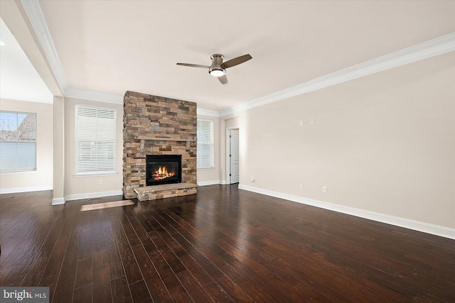 unfurnished living room featuring ceiling fan, dark hardwood / wood-style flooring, ornamental molding, and a fireplace