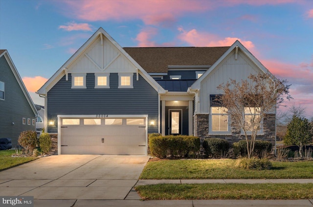 view of front of house with a garage and a lawn