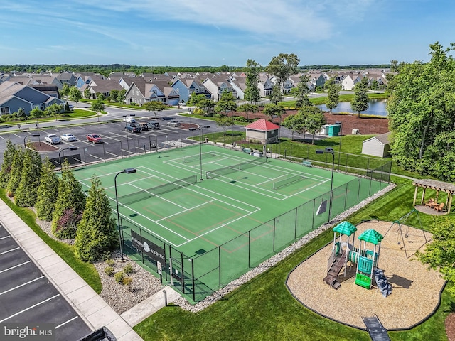 view of tennis court with a playground