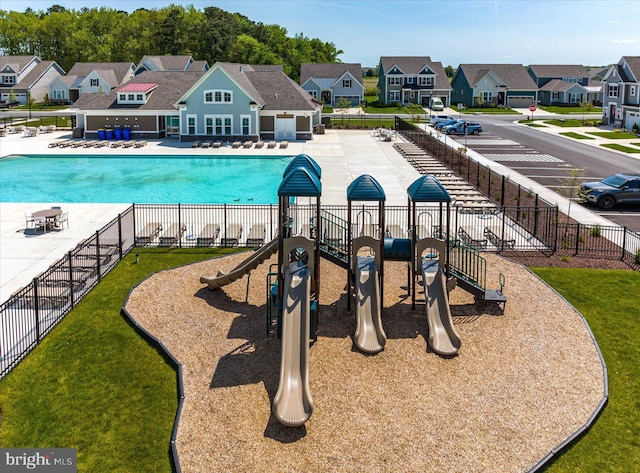 view of pool with a playground and a patio area