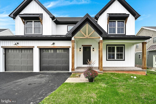 modern inspired farmhouse featuring a front yard and a garage