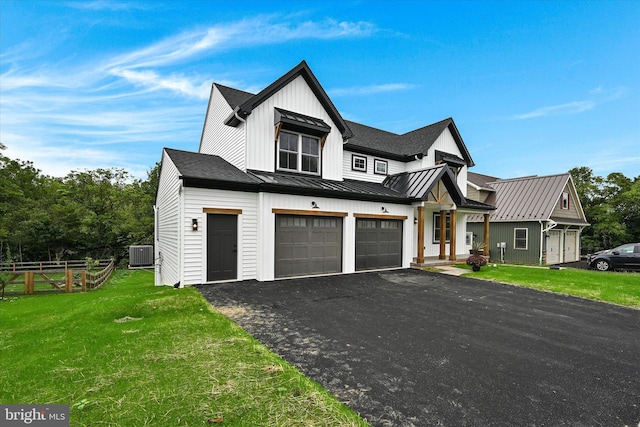 modern farmhouse with central AC unit, a garage, and a front lawn