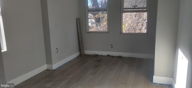 unfurnished room with dark hardwood / wood-style floors