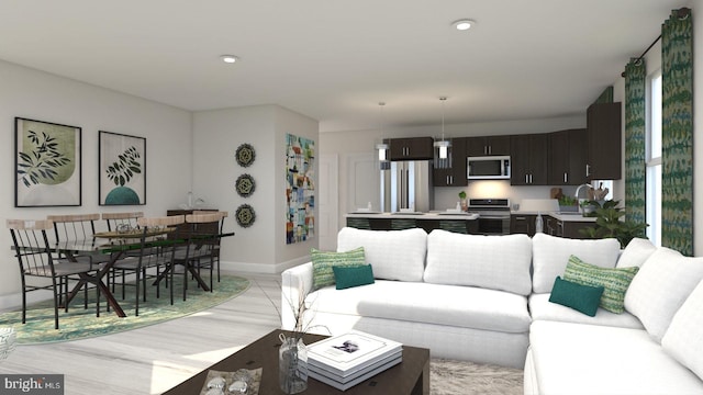 living room with light hardwood / wood-style flooring and sink