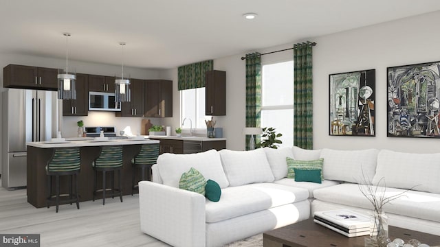 living room with sink and light hardwood / wood-style floors