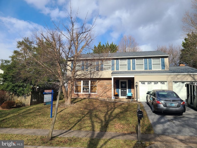 view of front property with a front yard and a garage