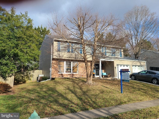 view of front of home with a garage and a front yard