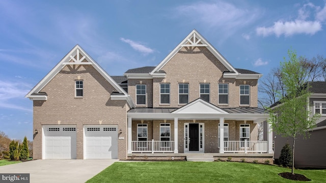 view of front of property with a front lawn, covered porch, and a garage