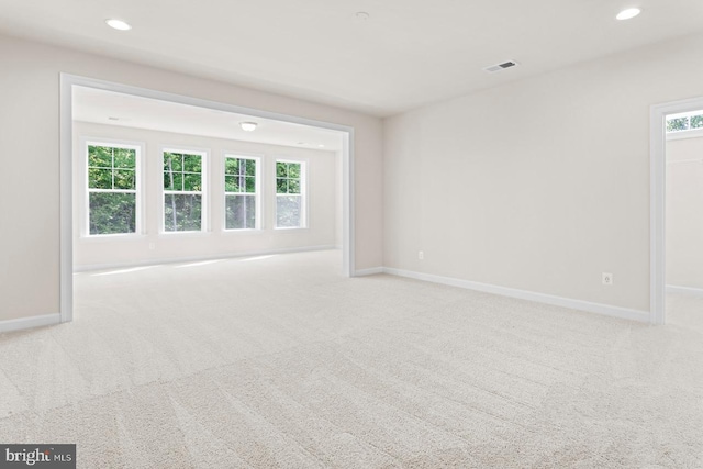 spare room featuring light colored carpet