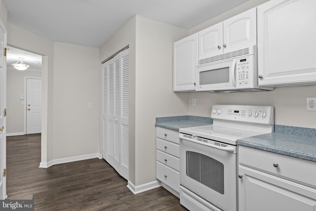 kitchen with white cabinetry, dark wood-type flooring, and white appliances