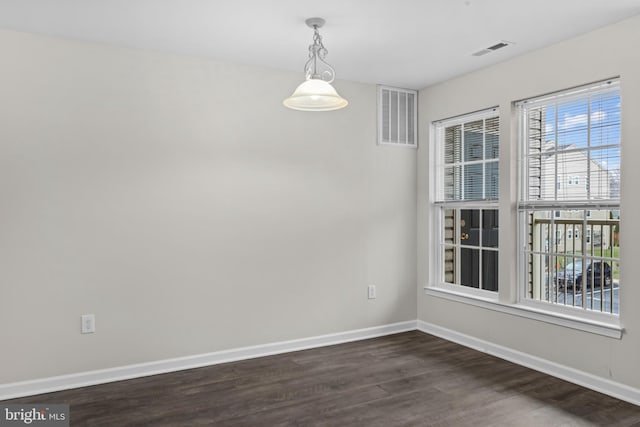 unfurnished dining area featuring dark wood-type flooring