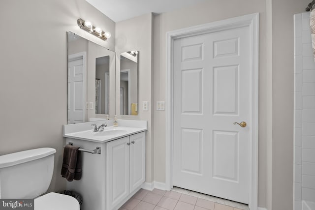 bathroom featuring tile patterned floors, vanity, and toilet