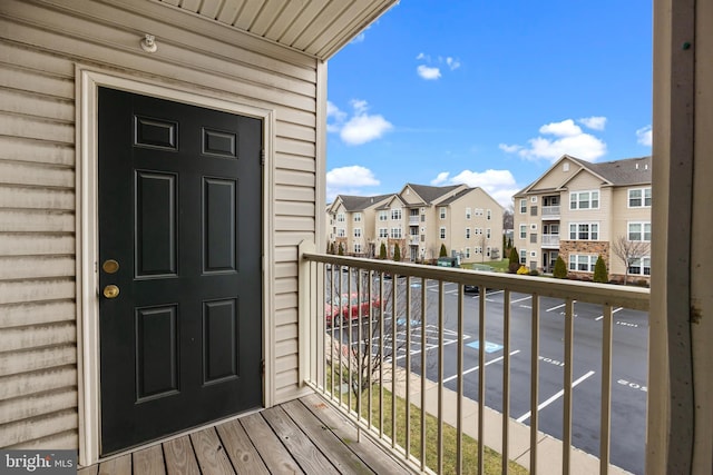 view of exterior entry with a balcony