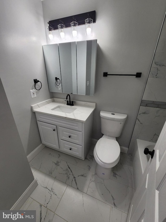 bathroom with vanity, toilet, and a tub