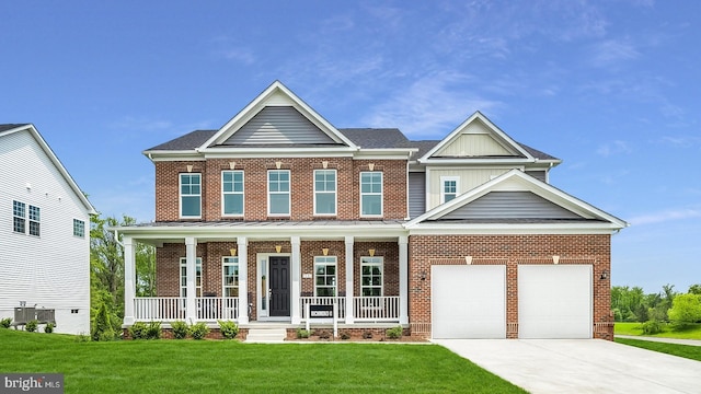 craftsman house with central AC unit, a porch, a garage, and a front lawn