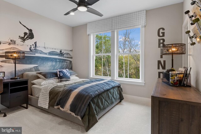 bedroom featuring ceiling fan and light carpet