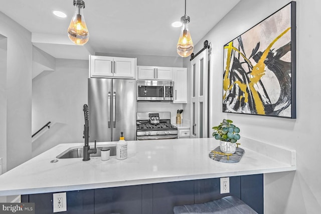 kitchen with stainless steel appliances, hanging light fixtures, sink, and white cabinets