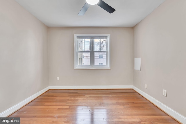 spare room with light wood-type flooring and ceiling fan