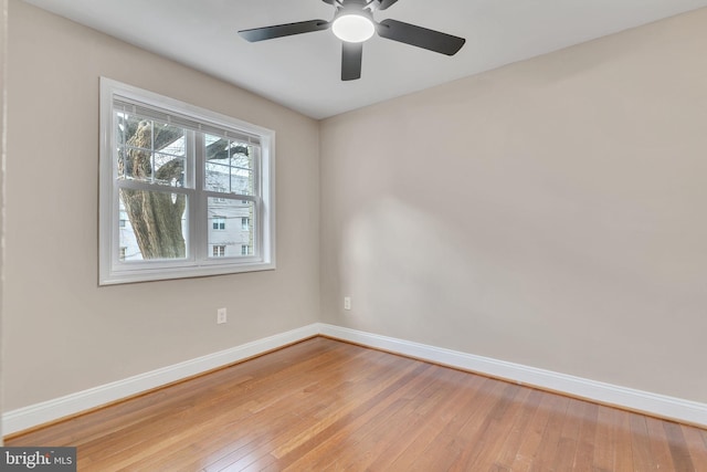 spare room featuring light wood-type flooring and ceiling fan