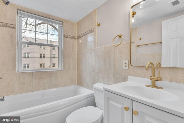 full bathroom with vanity, toilet, tile walls, and bathing tub / shower combination