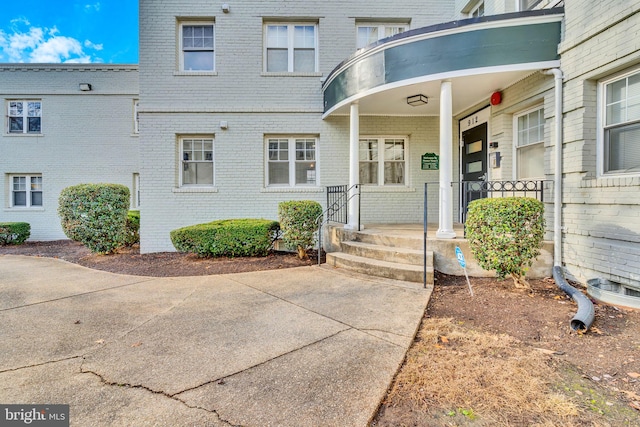 view of exterior entry featuring a porch